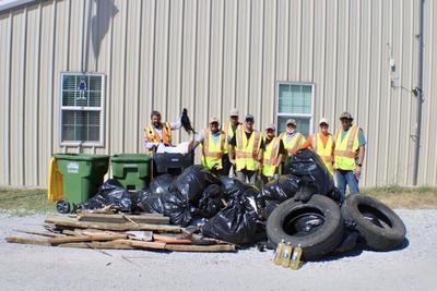 Cleanup crew near pile of tires